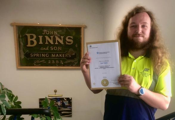 Sam with his Apprenticeship Completion Certificate